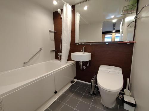 a bathroom with a white toilet and a sink at Guesthouse Mow-Mow - Vacation STAY 87600v in Osaki