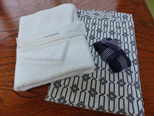 a pile of white towels on a table at Minshuku Kuwataniya - Vacation STAY 96483v in Takayama