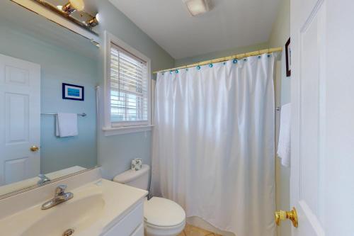 a bathroom with a sink and a toilet and a shower at Adel's Place #8-S in Salvo