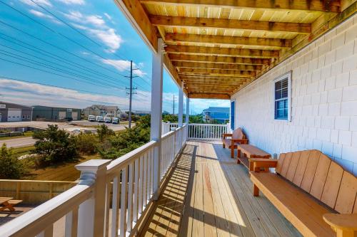 a porch with a bench and a view of the ocean at Adel's Place #8-S in Salvo