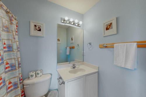 a bathroom with a sink and a toilet and a mirror at Adel's Place #8-S in Salvo