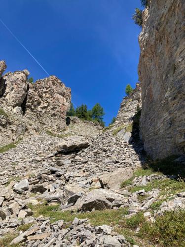 a rocky mountain with a blue sky in the background at Haus Rhodania in Albinen