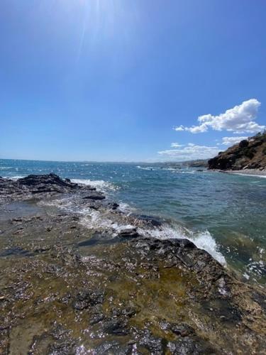 a view of the ocean from a rocky beach at Résidence Bario H in Al Hoceïma