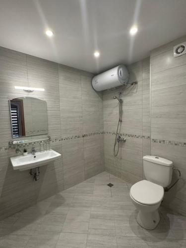 a bathroom with a toilet and a sink at Victoria Hotel Rooms Veliko Tarnovo &Victoria apartment in Veliko Tŭrnovo