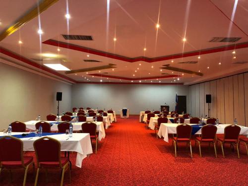 a large room with tables and chairs in it at Ramada by Wyndham Princess Belize City in Belize City