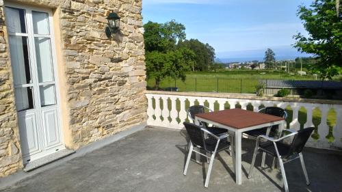 a wooden table and chairs on a patio at Casa Rubal in Foz