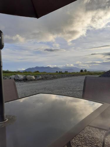 a table and chairs with a view of a road at Stable Hill House in Killarney