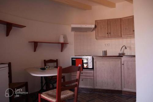 a kitchen with a table and a small table with chairs at A medieval windmill tower with magnificent view in Rhodes Town