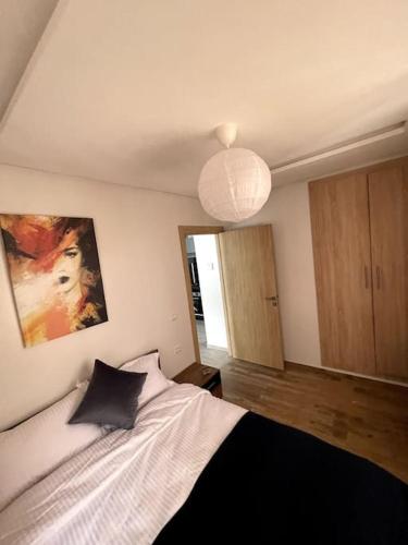 a bedroom with a bed with a black and white blanket at Modern Unit Well located in Casablanca