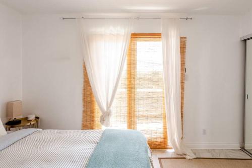 a bedroom with a bed and a large window at Malibu Ocean Villa with King Bed, Hot Tub, Beach, BBQ in Malibu