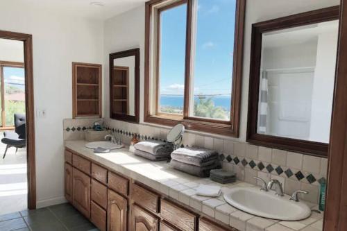 a bathroom with two sinks and two mirrors at Malibu Seaside Bliss with Hot Tub and Beach & Hike nearby in Malibu