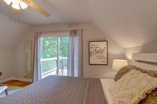 a bedroom with a bed and a large window at Blue Ridge Getaway with Hot Tub and Seasonal View! in Blue Ridge