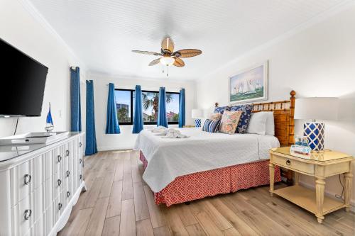 a bedroom with a bed and a flat screen tv at Stay Siesta Dunes, #300; by Beachside Management in Siesta Key