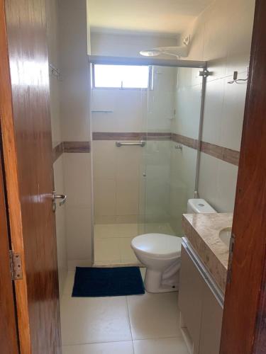 a bathroom with a toilet and a glass shower at Cond. Sonhos da Serra in Bananeiras