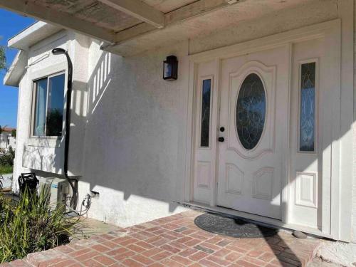 a white door of a house with a brick walkway at 30 PCT OFF! Malibu Romantic Suite, Ocean View, Beach in Malibu