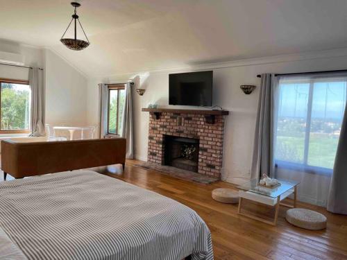 a living room with a bed and a fireplace at Malibu Coastal Romantic Getaway, Beach & Hike Nearby in Malibu