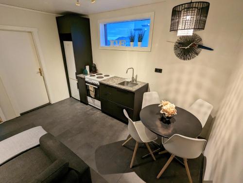 a kitchen and dining room with a table and a sink at Central Apartments in Vestmannaeyjar