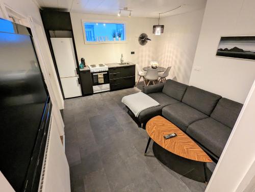 a living room with a couch and a table at Central Apartments in Vestmannaeyjar