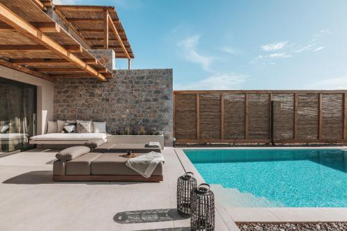 a villa with a swimming pool and a bedroom at Castor & Pollux in Kotrónion