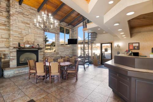 a dining room with a fireplace and a table and chairs at The Inn at Tomichi Village in Gunnison