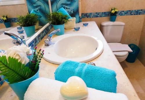 a bathroom with a sink and a toilet at Mirage Apartments & Aqua Park in Hurghada