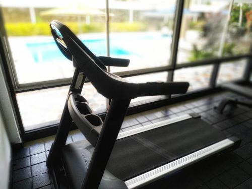 a black chair sitting in front of a window at Vallclaire Suites in Barranquilla