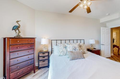 a bedroom with a large bed and a dresser at Renovar at The Club in Mexico Beach