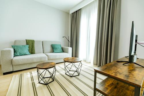 a living room with a couch and two tables at Apartamentos Villa Zoila Nigrán in Nigrán