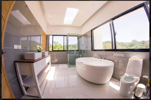 a large bathroom with a large tub and a sink at Villa Ocean Blue in Las Terrenas