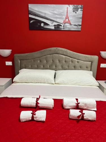 a bedroom with a bed with towels on a red carpet at Alì Babà Rooms in La Spezia