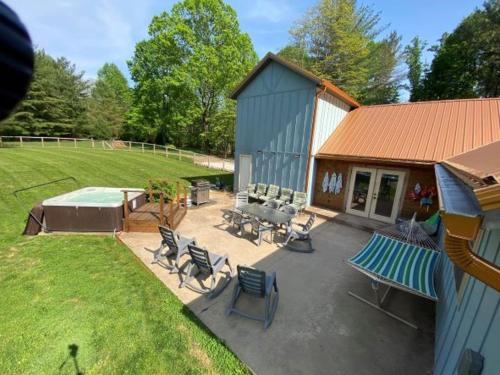 a backyard with a pool and chairs and a house at The Chateau in Bloomington