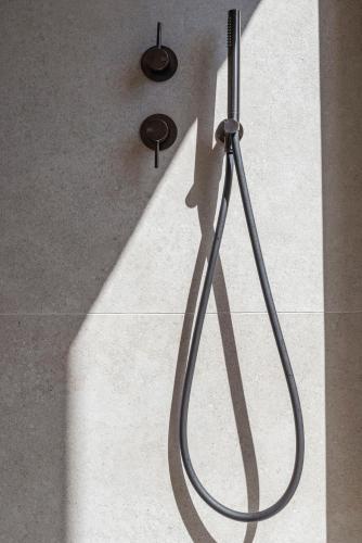 a shadow of a shower head in a bathroom at Maravilla Luxury Living in Kos Town