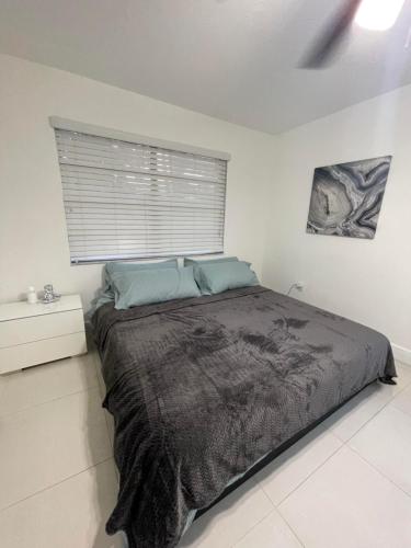 a bedroom with a large bed with a window at Modern Miami Oversized 3 Bedroom in Central Location in Miami