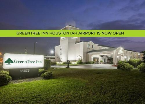 a building with a sign in front of it at GreenTree Inn - IAH Airport JFK Blvd in Houston