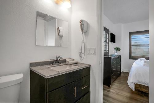 a bathroom with a sink and a phone on the wall at The Enclave - Unit 1601 in Orlando