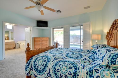 a bedroom with a bed and a ceiling fan at Bella Vista La Quinta Home with Pool and Spa! in La Quinta