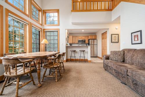 a living room with a couch and a table at Boyne Mountain Getaway, Unit A in Boyne Falls