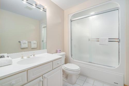 a white bathroom with a sink and a toilet at Boyne Mountain Getaway, Unit A in Boyne Falls