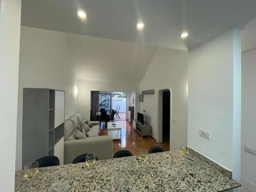 a living room with a table and a couch at Casa Princesa in Tías