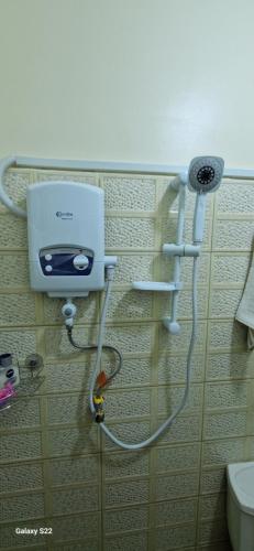 a bathroom with a toilet and a toaster on a wall at Frankfurt Cottages in Mbale