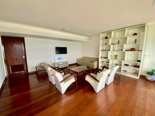 a living room with a table and chairs and a desk at Ondina Apart Hotel Residences in Salvador