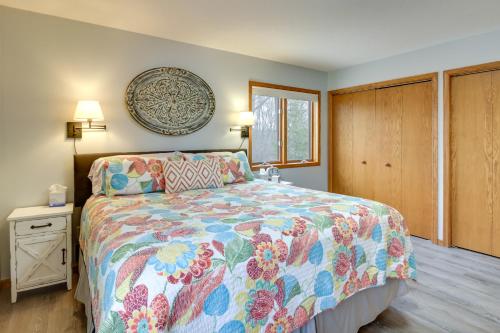a bedroom with a bed with a colorful bedspread at Private Lakefront Retreat with Hot Tub, Deck and Views in Spicer