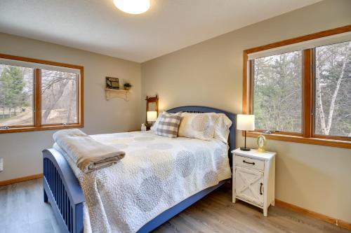 a bedroom with a bed and two windows at Private Lakefront Retreat with Hot Tub, Deck and Views in Spicer