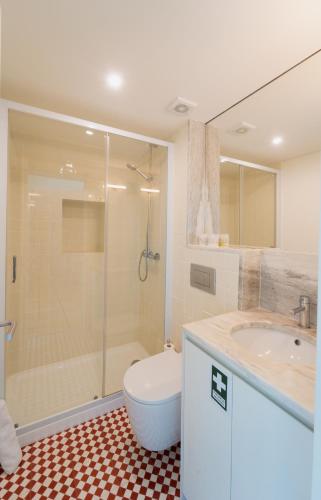a bathroom with a shower and a toilet and a sink at Casas de Vila Pouca in Mondim de Basto