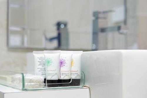 a shelf with three moisturizers on it in a laboratory at Mariners Court Hotel Sydney in Sydney