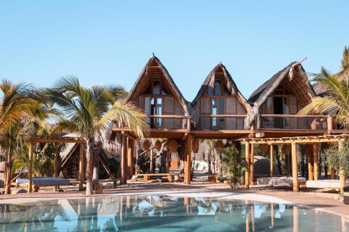 a house with a pool in front of it at Baja Nomads Hotel - Adults 15 Plus in Todos Santos