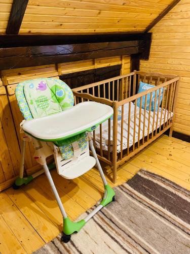 a baby crib sitting in the corner of a room at Котедж Chalet Adriana in Bukovel