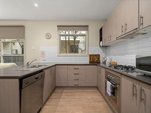 a kitchen with a sink and a counter top at Central Shepparton Apartments in Shepparton