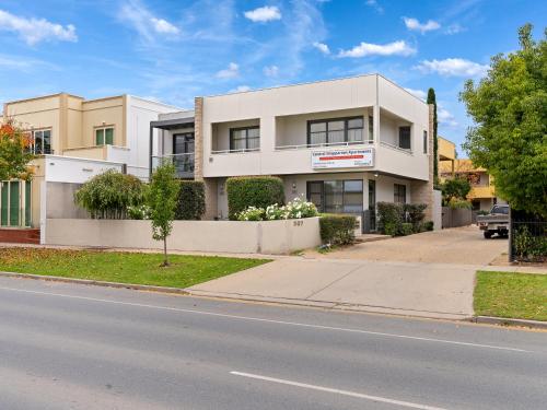 a white building on the side of a street at Central Shepparton Apartments in Shepparton