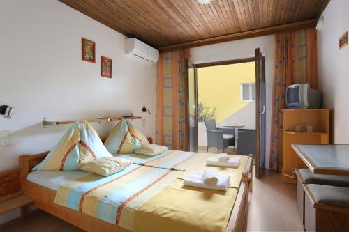 a bedroom with a bed with towels on it at Apartments and rooms by the sea Nemira, Omis - 2781 in Omiš